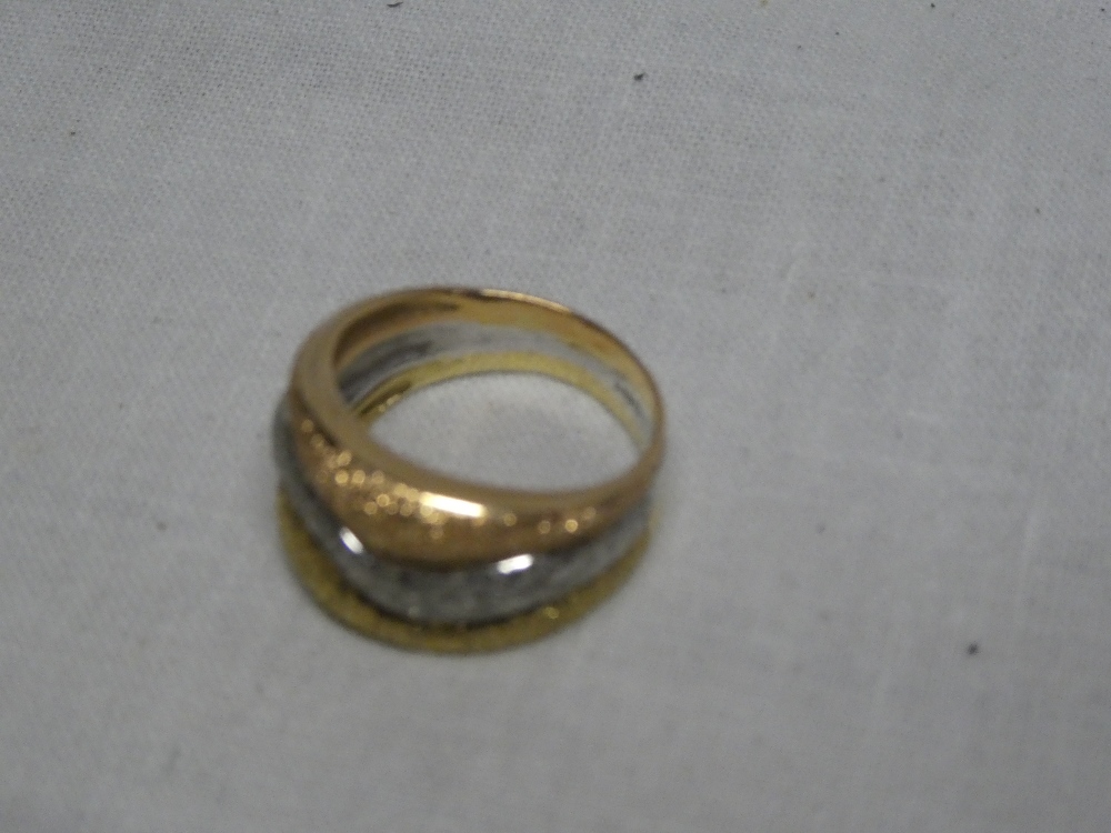 An 18ct three tone gold spiral twist dress ring