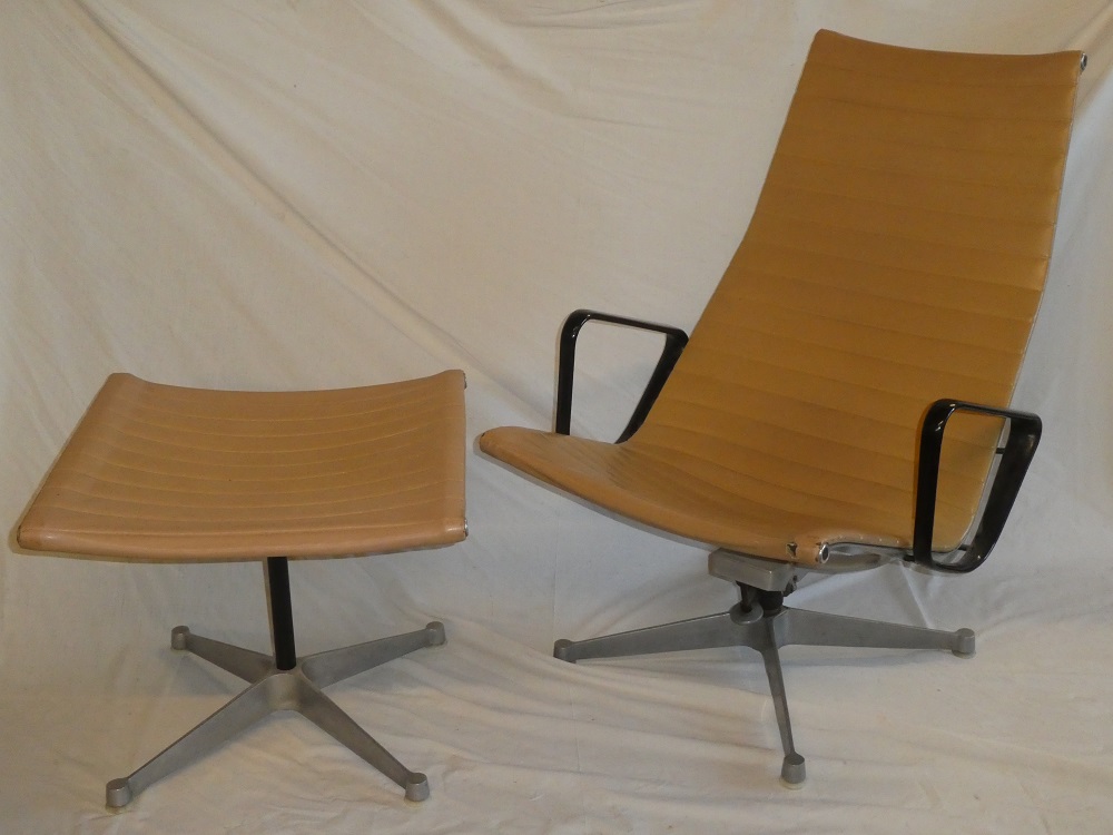 A 1960's aluminium and vinyl Eames swivel easy chair and matching footstool labelled "Eames Design