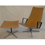 A 1960's aluminium and vinyl Eames swivel easy chair and matching footstool labelled "Eames Design