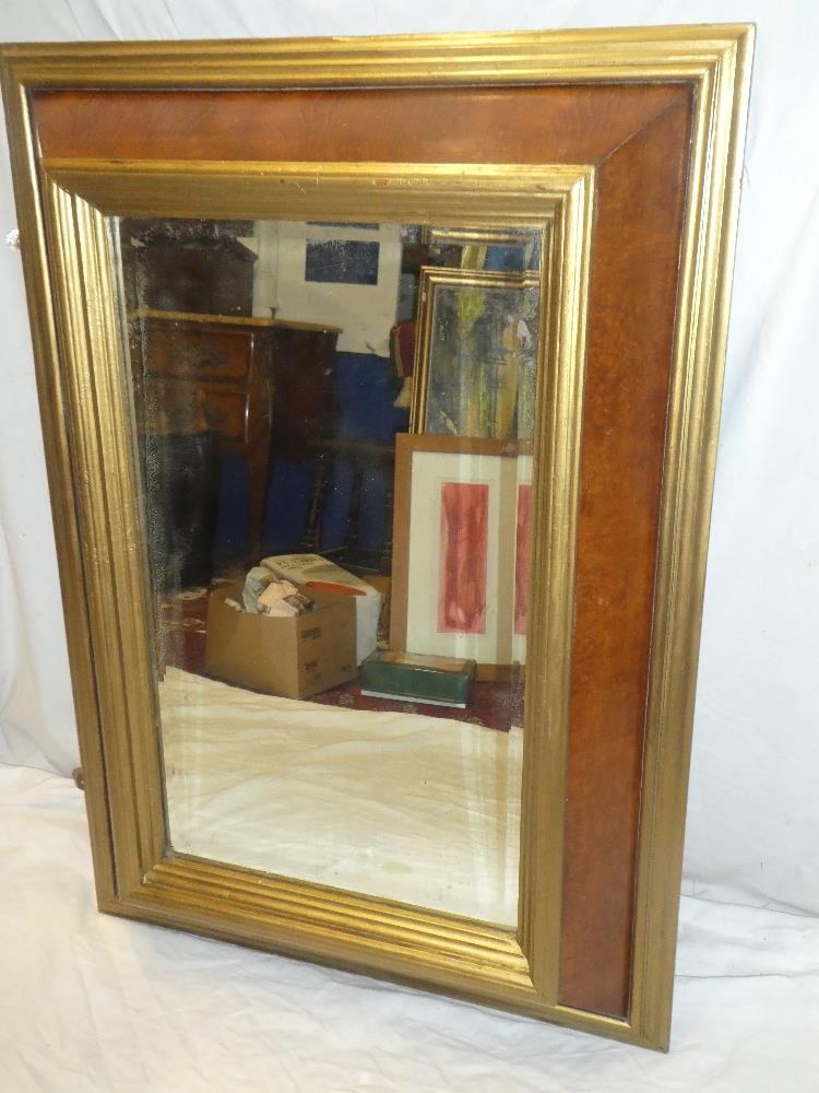 A bevelled rectangular cushion-framed mirror with polished walnut and gilt painted decoration 42" x