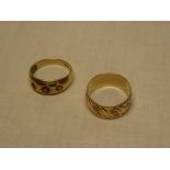 A 9ct gold engraved wedding band and a 9ct gold gypsy style dress ring set with garnets (2)