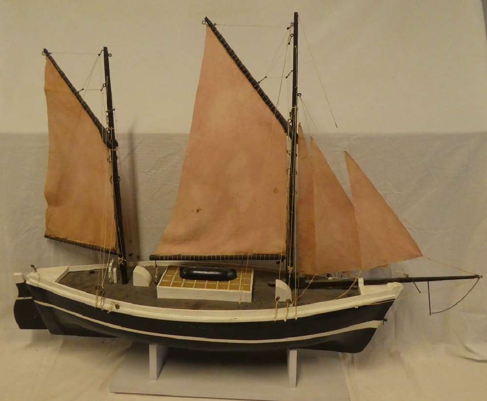 An old painted wood model boat based on a Looe lugger with linen sales and deck detail,