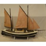An old painted wood model boat based on a Looe lugger with linen sales and deck detail,