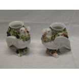 A pair of Continental china vases in the form of doves with attached vases decorated with