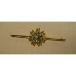 A 9ct gold bar brooch with floral mounts set opals