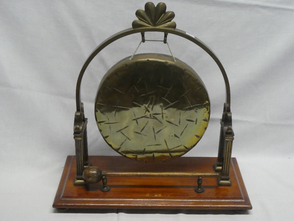 A good quality old brass arched gong stand with gong and beater on rectangular oak base