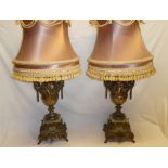 A pair of good quality brass and onyx classical-style table lamps with scroll decoration and raised