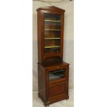 A Victorian walnut slim display cabinet with fabric lined shelves enclosed by a glazed fall front