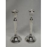 A pair of good quality silver tapered candlesticks on circular spreading bases,