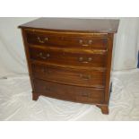 An Edwardian/1920's inlaid mahogany bow-front chest of four long graduated drawers below a brushing