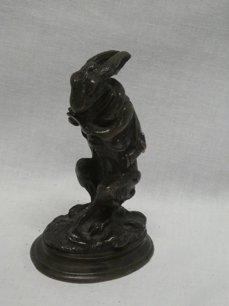 A good quality bronze figure of a crouching hare dressed in hunting clothing in the style of AN