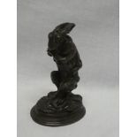 A good quality bronze figure of a crouching hare dressed in hunting clothing in the style of AN