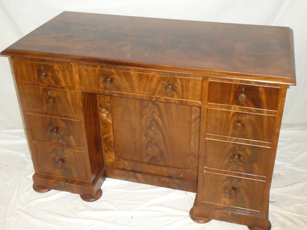 A Victorian figured mahogany rectangular kneehole desk with three drawers in the frieze,