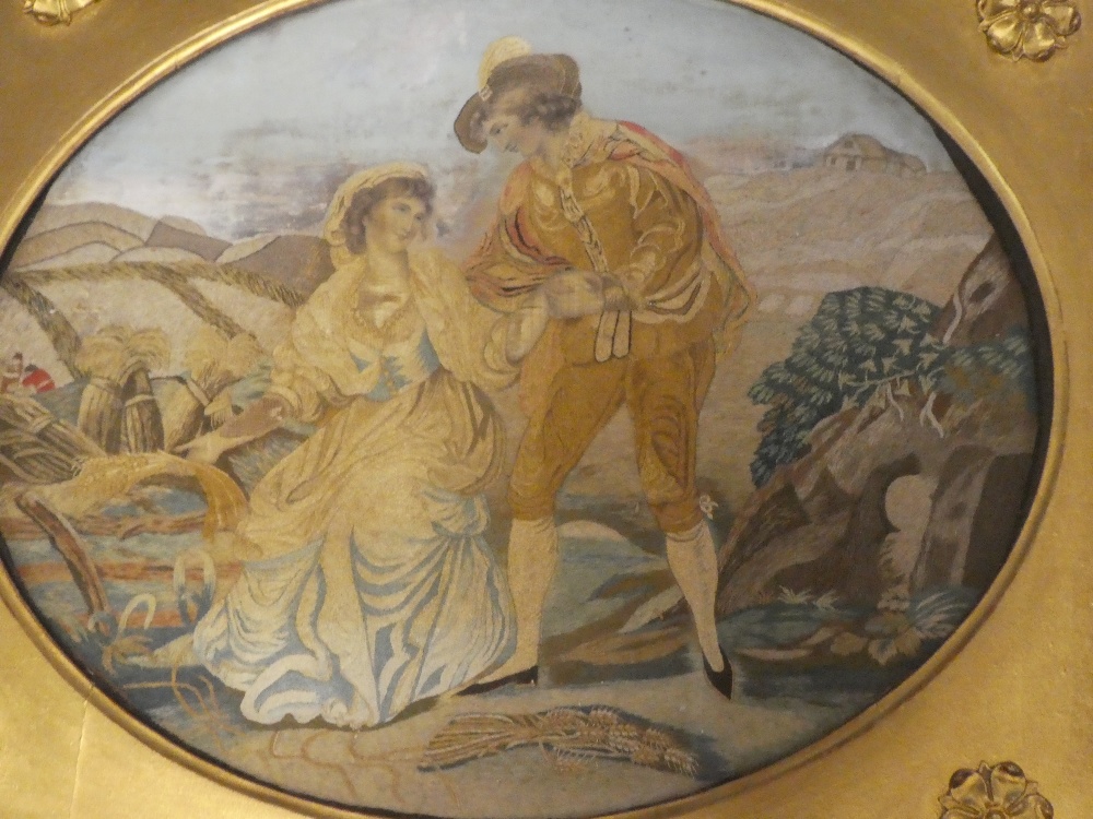 A George III embroidered silk-work oval panel depicting a male and female in a country clearing 12" - Image 2 of 2