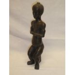 An African -style bronze figure of a seated male,