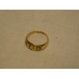 An 18ct gold gypsy-style dress ring set three diamonds