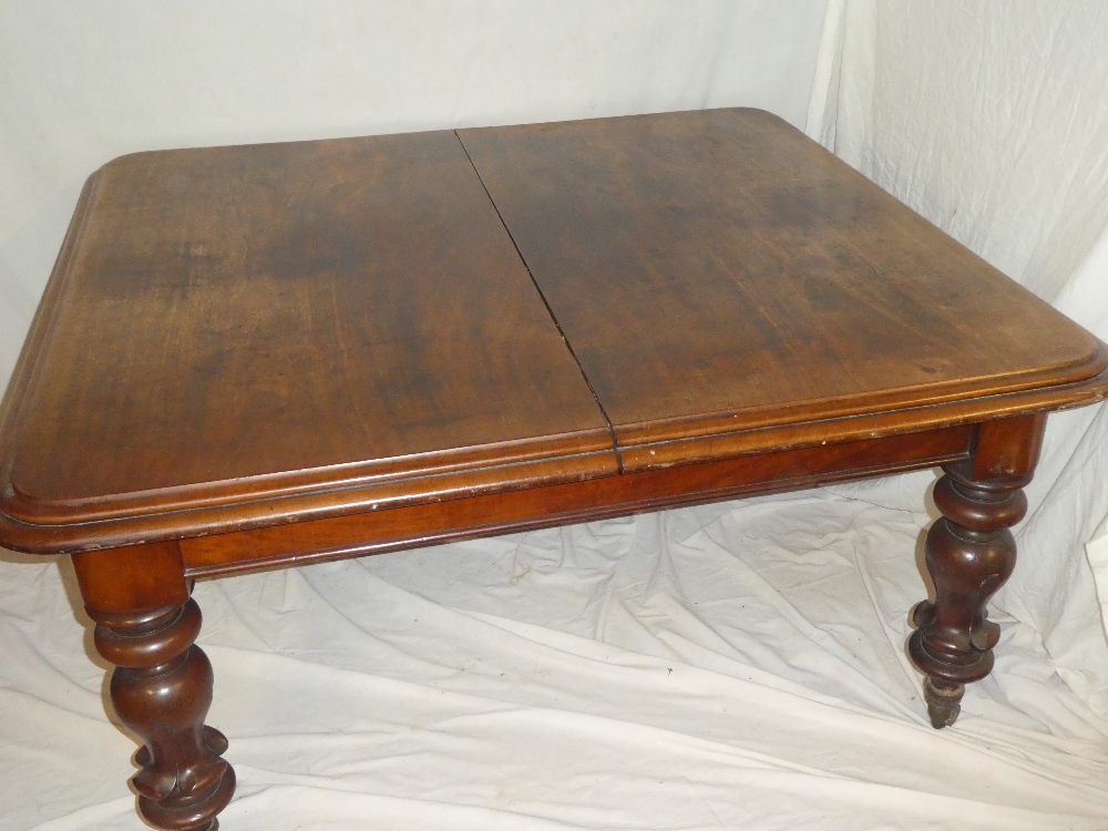 A Victorian mahogany rectangular extending dining table on bulbous turned tapered legs with brass - Image 2 of 2