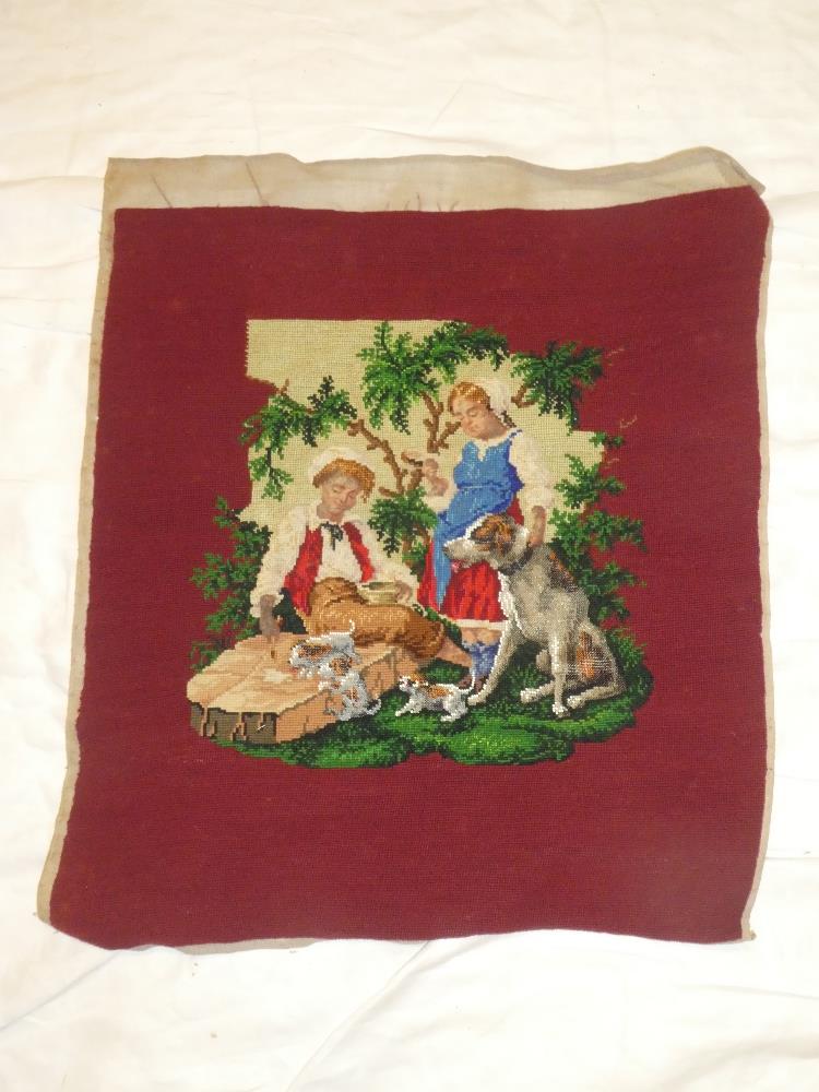 A 19th Century needlework and beadwork embroidered panel depicting two children with dogs in a