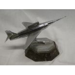 An unusual chromium plated table lighter in the form of an aircraft on serpentine octagonal base