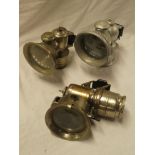 Three various motorcycle carbide lamps including Lucas Lucia 250, Lucas 153 Calcia,