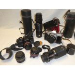 A Minolta X-700 camera with a selection of various lenses together with a Praktica LTL3 camera and