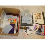A large box containing various albums and catalogues, postal stationery, first day covers,