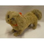 An old plush covered straw filled dog 12" long