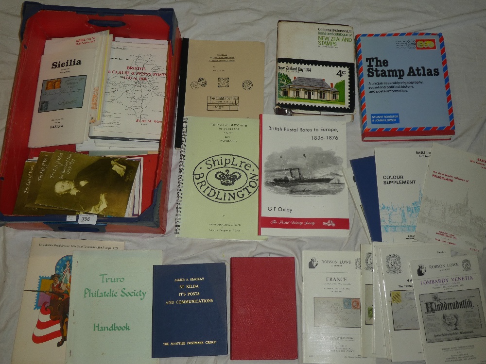 A box containing various stamp volumes and literature including Solomon Islands,