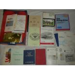 A box containing various stamp volumes and literature including Solomon Islands,