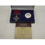A First War silver 1914-1918 commemorative crown with accompanying replica First War Victoria Cross