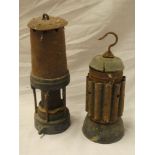 An old brass mounted steel bonetted miner's lamp and one other miner's lamp with ribbed body (2)