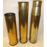 Three large brass shell cases including 4.