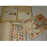 Two albums containing a selection of World stamps, an album of various postal covers,