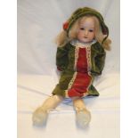 A German porcelain headed child's doll marked "Germany GB" with composition jointed body 22" long
