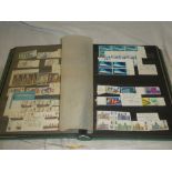 A stock book containing a collection of GB mint stamps 1960's-1970's including strips, pairs,