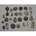 A selection of various military badges and insignia including Border Regiment, 7th Dragoon Guards,