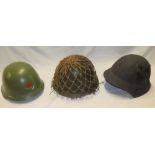 Three various military helmets including Japanese-style helmet, Chinese,
