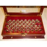 Fifty US gilt Liberty one dollar coins 2008 contained in a fitted glazed mahogany display cabinet
