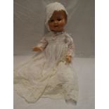 A 1930/40s child's composition doll in christening gown with cap,