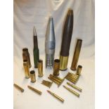 A selection of various inert ordnance and shell cases including armoured practice shell,