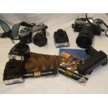 An Olympus OM10 camera with 28-80mm lens and an Olympus OM2 camera together with flash units and
