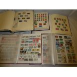 An album and two stock books containing a selection of GB stamps together with two albums of mixed