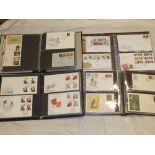 Four folder albums containing a selection of GB first day covers