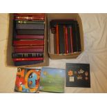Two boxes containing a large selection of empty stamp albums, stock books,
