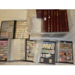 Thirteen matching stock books containing a large collection of mixed world stamps