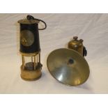 An old brass and steel bonnetted miner's lamp by the Protector Lamp & Lighting Co.