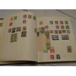 An album containing a collection of Australia stamps including kangaroo heads, commemoratives,
