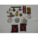 A 1939/45 War medal together with Defence medal, two DCLI cap badges Gloucester Regiment cap badge,