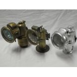 Four various old motoring lamps including French Favorit brass carbide lamp; P & H carbide lamp;