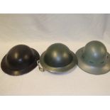 Three various British Steel helmets including black painted helmet dated 1941
